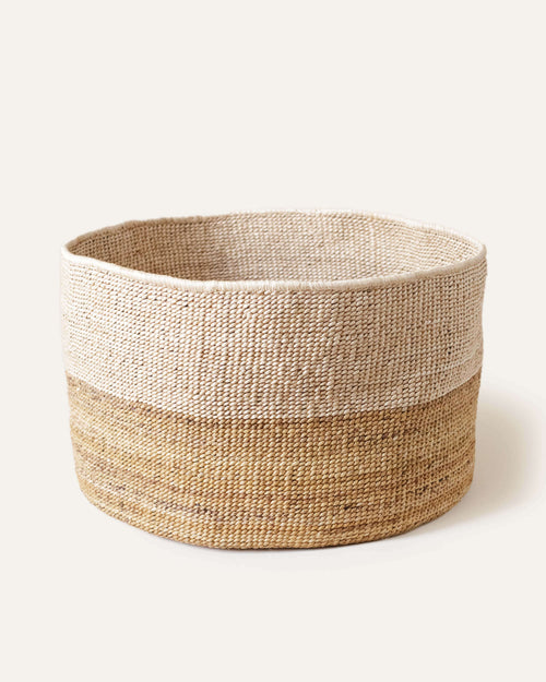 Woven basket with two-tone design on a white background